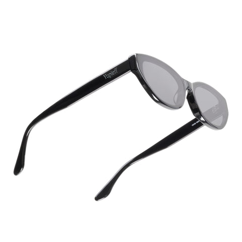 Black cat-eye sunglasses with gray tinted lenses, shown from a side angle on a white background.