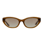 Cat-eye sunglasses with a translucent amber-brown acetate frame and gradient brown lenses, shown against a plain white background.
