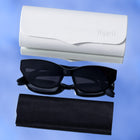 Black cat-eye sunglasses with dark lenses, shown with a white hard case and a black soft case on a blue gradient background. The embossed brand name 'Yupieff' is visible on both cases.