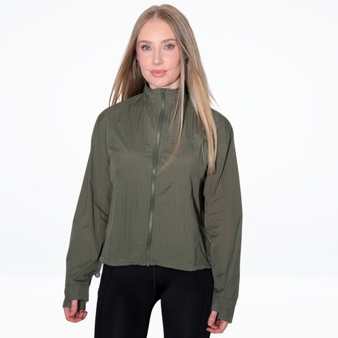 Woman wearing a green jacket on a white background